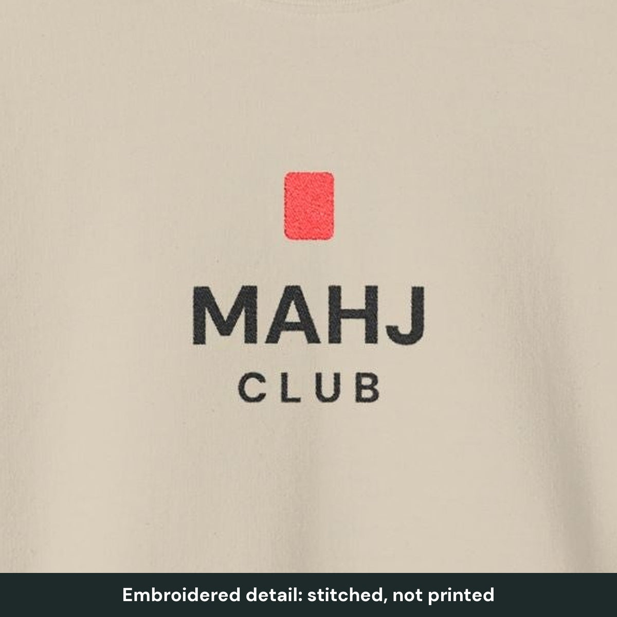 Close-up of the embroidered MAHJ CLUB design and red tile