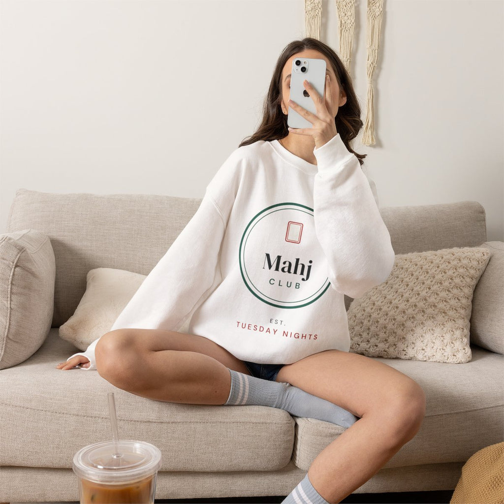 Mahj Club, Est. Tuesday Nights mahjong sweatshirt worn on the sofa, shown in White