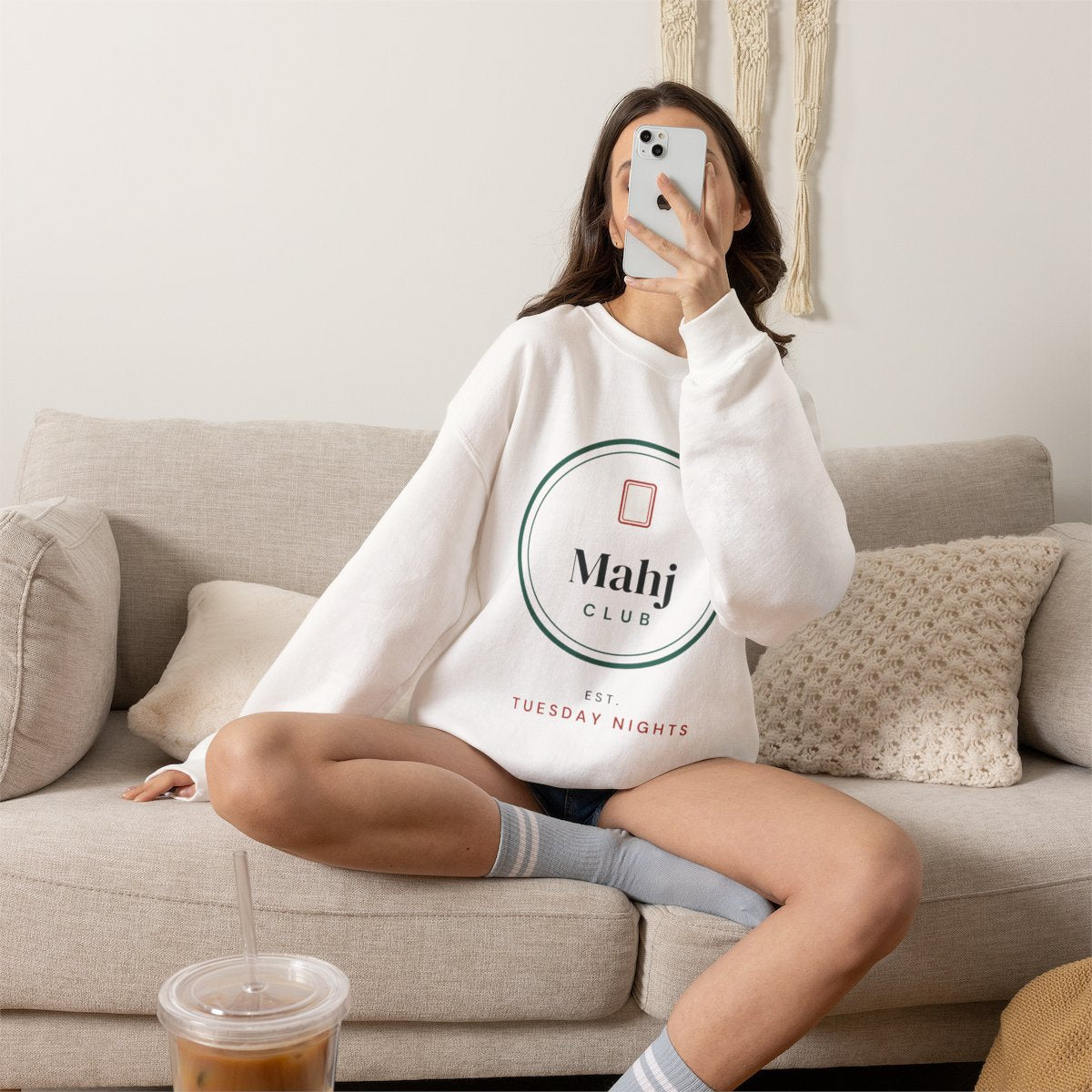 Mahj Club, Est. Tuesday Nights mahjong sweatshirt worn on the sofa, shown in White