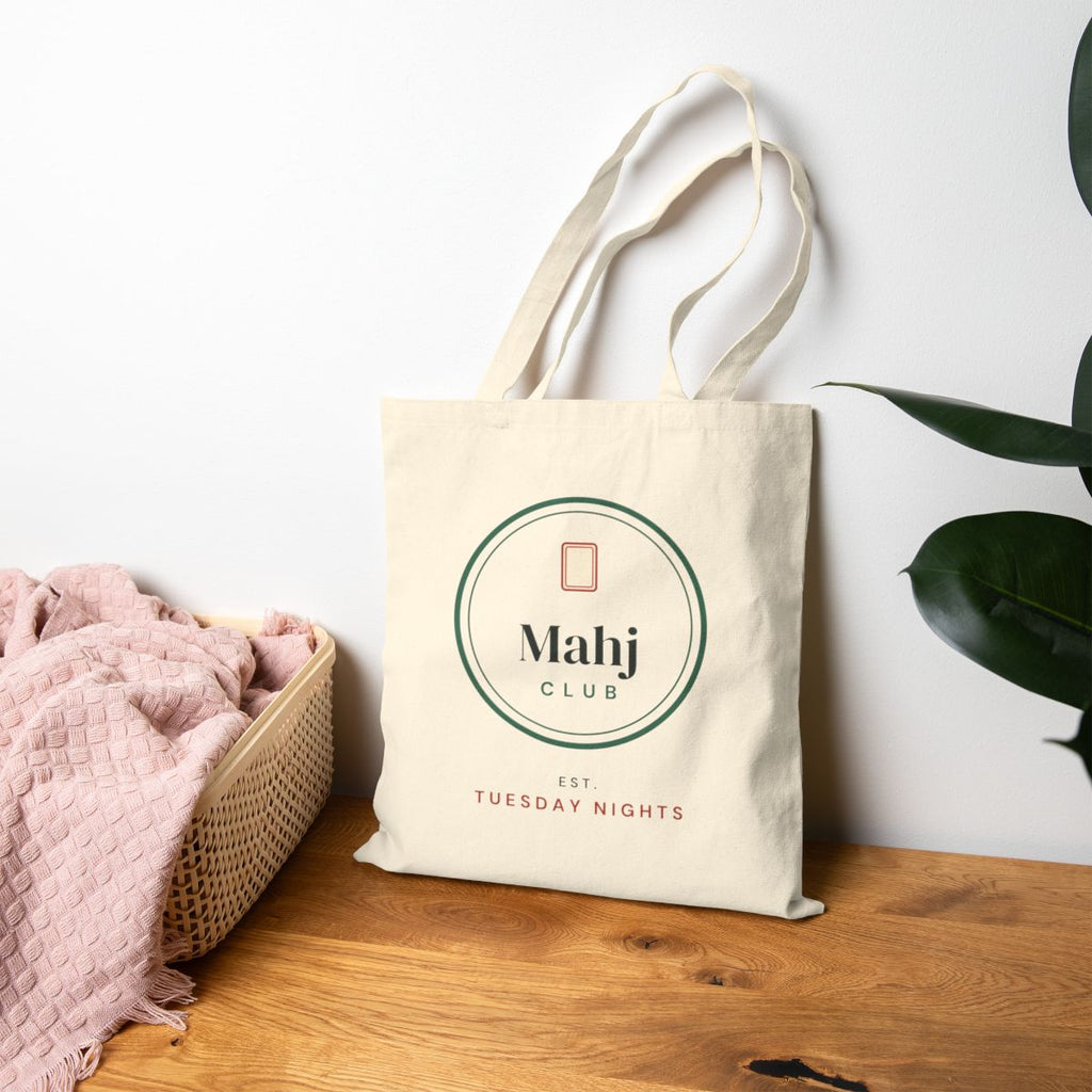 Mahj Club, Est. Tuesday Nights mahjong canvas tote bag on a table