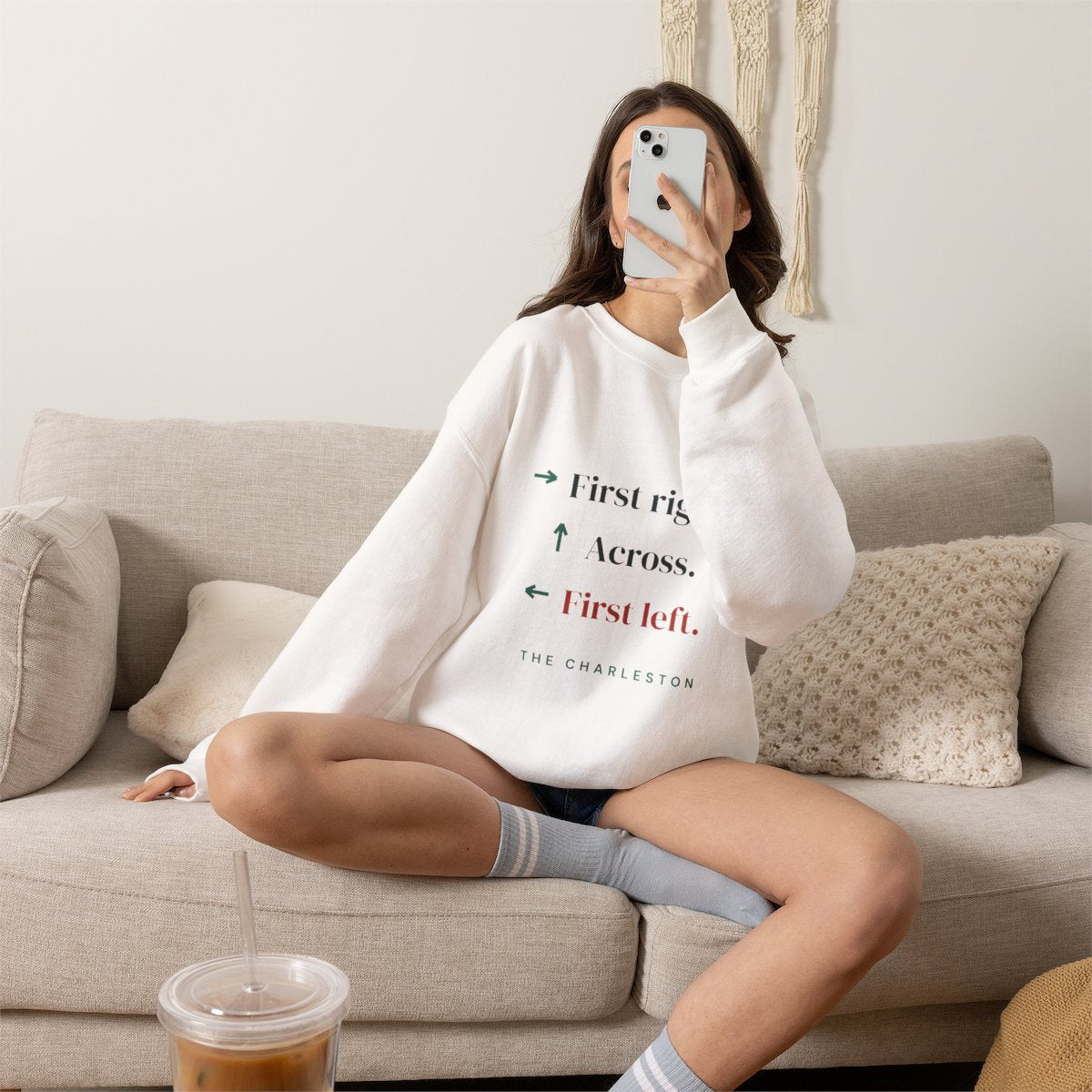 The Charleston mahjong sweatshirt worn on the sofa, shown in White